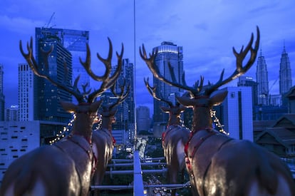 Vista de las icónicas Torres Gemelas de Pertonas, desde un restaurante colgante suspendido en una grúa en Kuala Lumpur (Malasia), inspirado por el viaje de Papá Noel en un trineo con renos, el 5 de diciembre de 2018. Los clientes del restaurante Santa in the sky se ubican en asientos similares a una montaña rusa, mientras cenan y beben, con el tráfico de la ciudad a sus pies y la panorámica de Kuala Lumpur en el horizonte.