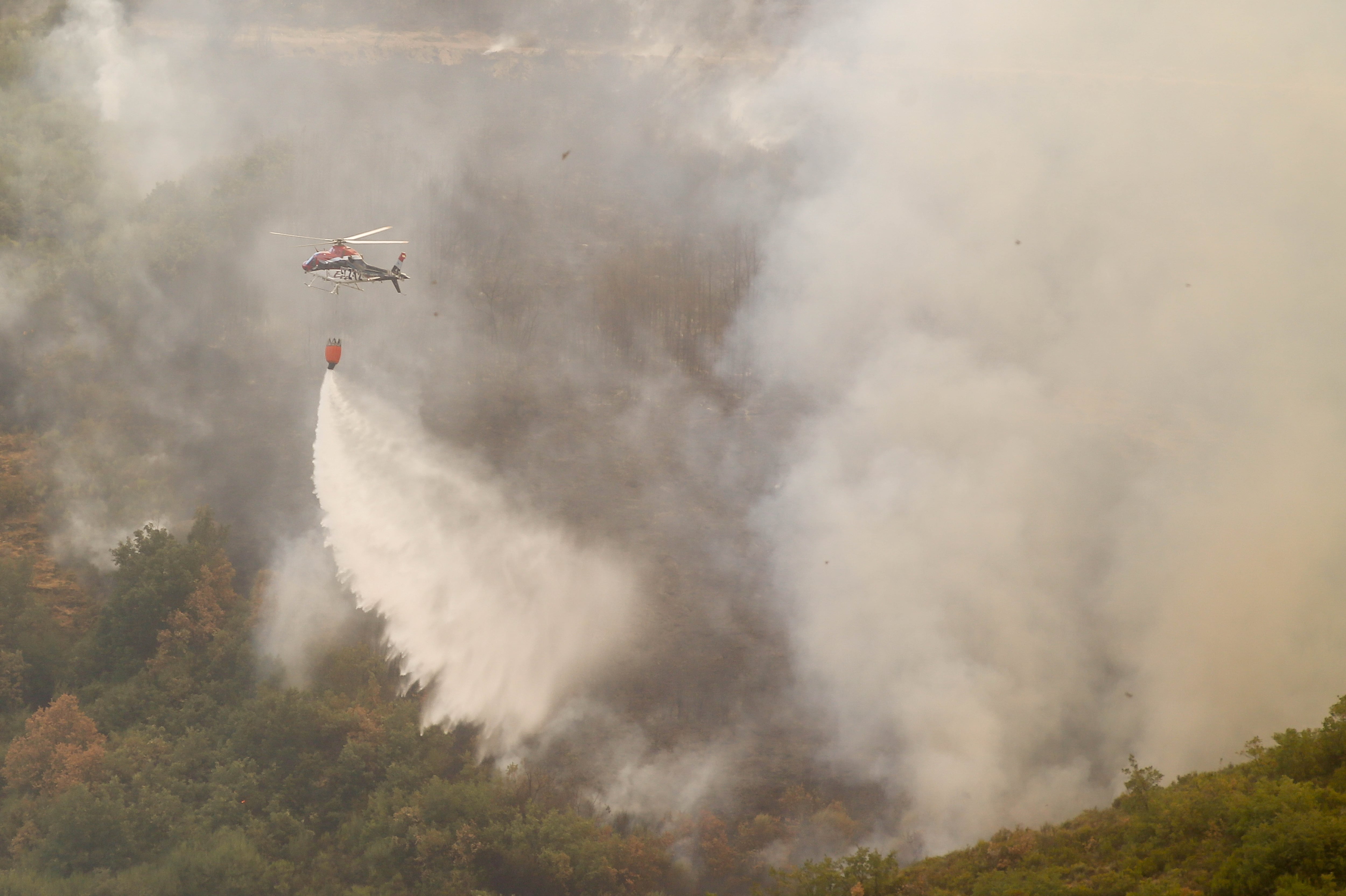 Un hidroavión trabaja en las tareas de extinción del incendio forestal en La Baña (Encinedo, La Cabrera, León), el domingo.