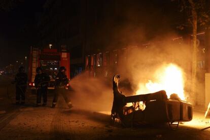 Protesters set a container on fire in Barcelona's Gràcia neighborhood.