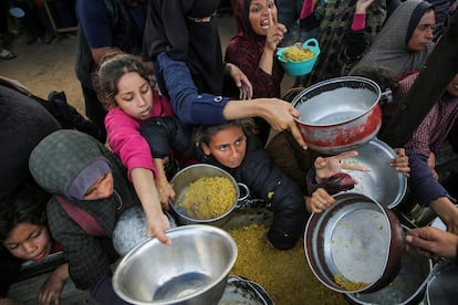 Mujeres y ni?as palestinas esperan el turno para recibir comida en Jan Yunis, al sur de la Franja, este viernes.