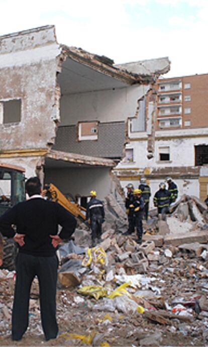 Los bomberos intentaban rescatar ayer el cuerpo del joven sepultado por los escombros del edificio.