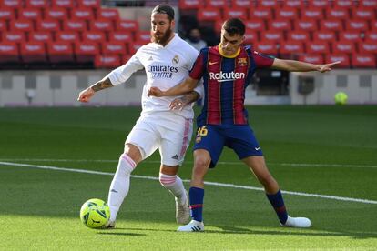 Ramos (a la derecha), del Real Madrid, y Pedri, del Barça, luchan por la pelota.