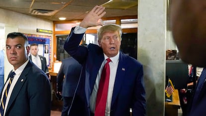 Former President Donald Trump waves as he departs after a visit with campaign volunteers at the Elks Lodge, Tuesday, July 18, 2023, in Cedar Rapids, Iowa.