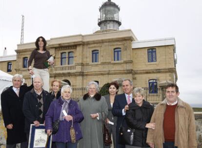 La actual farera de Matxitxako, Cristina García (de pie), junto a ex torreros y sus familiares, ayer, frente al faro.