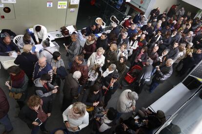 Voters line up at midday to cast their vote at the Terrassa Municipal Music School in Barcelona province.