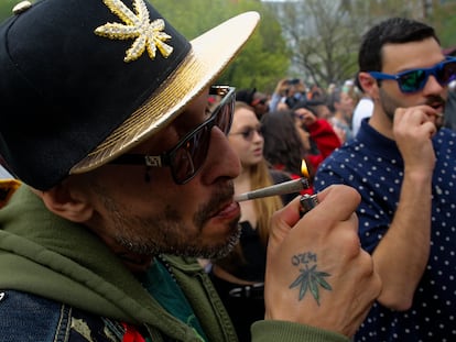 A man lights a marijuana cigarette