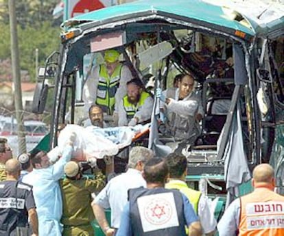 Los servicios de socorro israelíes trasladan el cuerpo de una de las víctimas mortales del atentado contra un autobús, ayer en Meron.