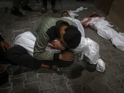 A Palestinian youth mourns his relative killed in the Israeli bombardment of the Gaza Strip, at the morgue of the Kuwaiti Hospital in Rafah refugee camp, southern Gaza Strip, early Saturday, April 20, 2024.