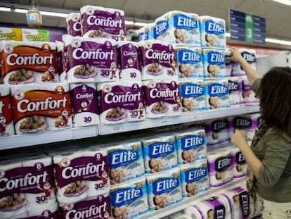 A woman purchases toilet paper at a supermarket in Santiago.
