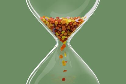 Digitally generated image of colored dollar coins hourglass. Time is money