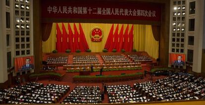Chinese Premier Li Keqiang appears on big screens as he delivers the work report at the opening session of the annual National People's Congress in Beijing's Great Hall of the People, Saturday, March 5, 2016.(AP Photo/Ng Han Guan)