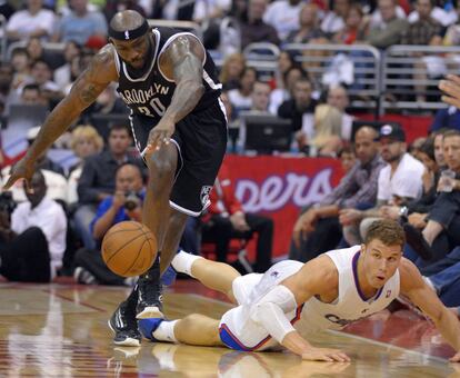 Griffin, en el suelo, ve cómo Evans se lanza a por el balón en el Clippers-Nets.
