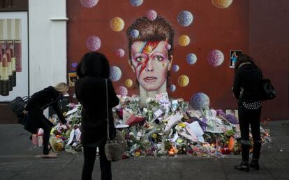 Altar espontáneo junto a un mural dedicado a Bowie en Londres.