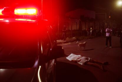 The father of a young man shot dead approaches his body in Manaus, Amazonas State, Brazil, in November 2021.