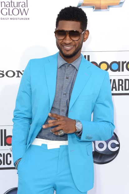 El cantante Usher, mentor de Justin Bieber (de hecho posan de la misma forma), con traje azul turquesa.