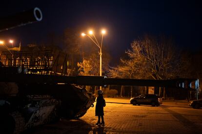 A woman stands in front of a display of destroyed Russian tanks and armored vehicles in downtown Kyiv, Ukraine, Friday, Jan. 20, 2023.