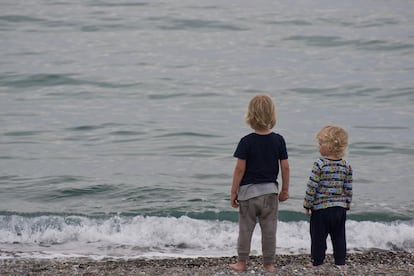 Dos niños observan el horizonte.