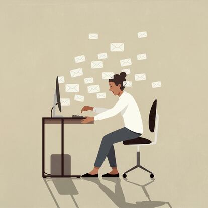 Businesswoman sending emails at computer at office desk
