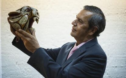 Guerrero state interim governor, Rogelio Ortega Martínez, holds up a porcelain tiger head.