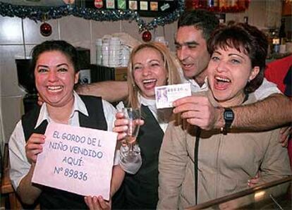 Varios afortunados con el Gordo celebran su suerte en el bar Avenida13, del distrito de San Blas.