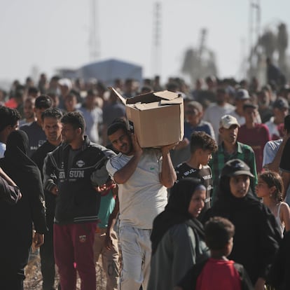 Palestinians carry boxes containing food and humanitarian aid packages delivered by the Gaza Humanitarian Foundation, a U.S.-backed organization approved by Israel, in Rafah, southern Gaza Strip, on Tuesday, May 27, 2025. (AP Photo/Abdel Kareem Hana)