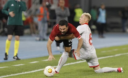 Turkey's Arda Turan, center, is challenged by Macedonia's Ezgjan Alioski, right, during an international friendly soccer match at the Philip II National Stadium in Skopje, Macedonia, on Monday, June 5, 2017. (AP Photo/Boris Grdanoski)