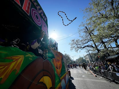 Members of the Krewe of Zulu parade throw beads from a float during Mardi Gras on Tuesday, March 1, 2022, in New Orleans.