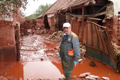 Yula Togolich, vecino de la localidad húngara de Kolontar, junto a su vivienda destruida por el vertido.