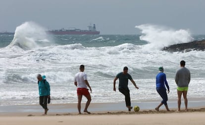 Unos jóvenes juegan el fútbol en una playa de Tarragona. 