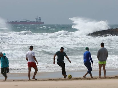 Unos jóvenes juegan el fútbol en una playa de Tarragona. 