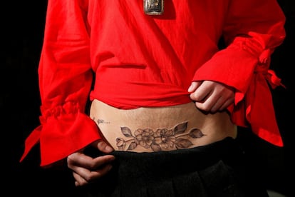 Kiki tiene 25 años y es madre de un niño de cinco. Muestra su nuevo tatuaje sobre la cicatriz de su cesárea. "Es mi quinto tatuaje. Me gustan las flores", asegura.