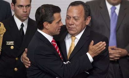 Peña Nieto hugs opposition leader Jesús Zambrano after signing the reform in 2013.