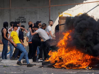 Palestinian demonstrators clash with the Israeli army while forces carry out an operation in the West Bank town of Nablus, Tuesday, Aug. 9, 2022.