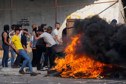 Palestinian demonstrators clash with the Israeli army while forces carry out an operation in the West Bank town of Nablus, Tuesday, Aug. 9, 2022.