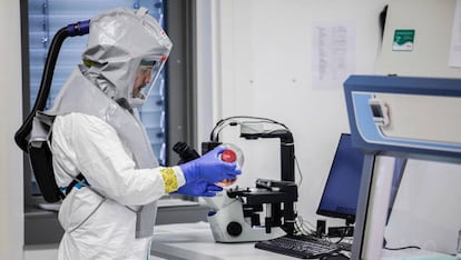 A lab technician handling a vaccine at Valneva Labs in Vienna (Austria).