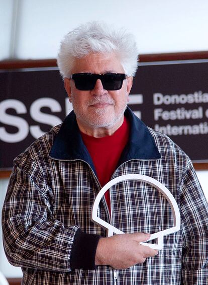 El cineasta manchego Pedro Almódovar sujeta el logotipo del Festival de San Sebastián para la prensa.