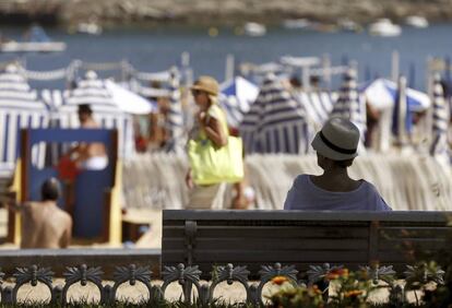 Una mujer a la sombra en la playa de Ondarreta de San Sebasti&aacute;n