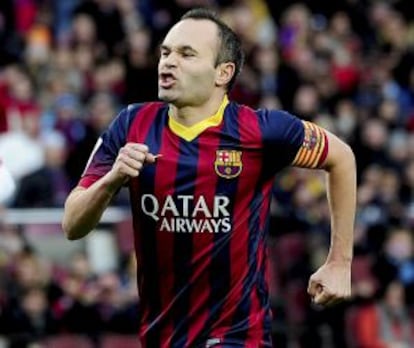 Barcelona's midfielder Andrés Iniesta celebrates after scoring during the Spanish league football match FC Barcelona vs Granada CF at the Camp Nou stadium in Barcelona on November 23, 2013.