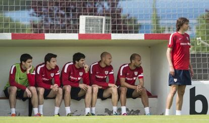 Iturraspe, de pie, y varios de sus compañeros en el banquillo siguiendo un entrenamiento del Athletic.