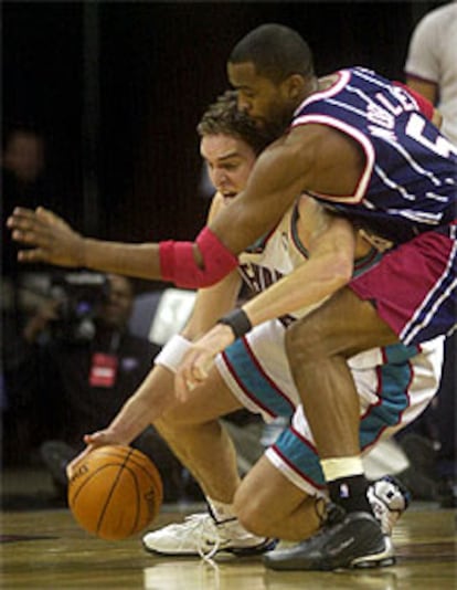 El español lucha por el balón con el jugador de los Rockets de Houston Cuttino Mobley.