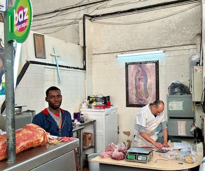 France Nore (left) and Mario Zamora at work in the latter’s butcher shop, located in Mexico City’s Benito Juárez Market.