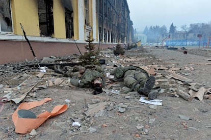 Los cuerpos de dos soldados rusos, junto a una escuela destruida durante los combates en la ciudad de Járkov.