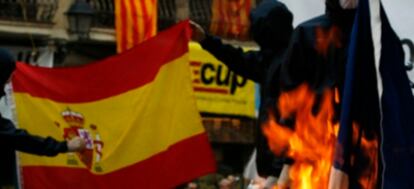 Una bandera española y otra francesa, quemadas tras una manifestación independentista en Barcelona.