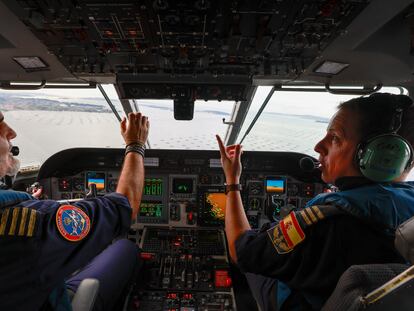 Los pilotos Chete y Juan, este jueves en la cabina del avión 'Rosalía de Castro-Sasemar 102', durante la búsqueda de sacos de 'pellets'.