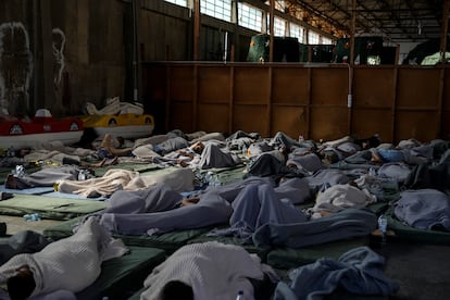 Survivors of the shipwreck rest in a warehouse in the port of Kalamata, 150 miles from Athens.