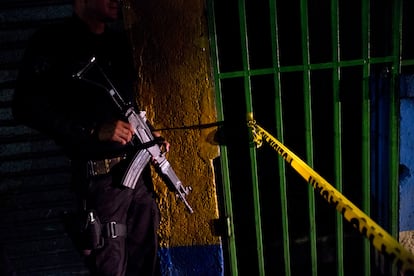 A police officer stands guard outside a crime scene in San Salvador.