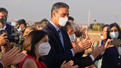 Spain's PM Pedro Sanchez (c) and Defense Minister Margarita Robles (to his right) receiving Afghan evacuees at the Torrejón military base in Madrid on August 27, 2021. 