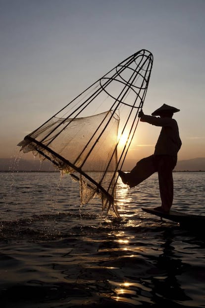 Un hombre pescando a la luz del atardecer.