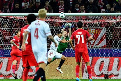 El portero del Spartak Alexander Selikhov despeja el balón en un intento de remate por parte del jugador del Sevilla, Nolito.