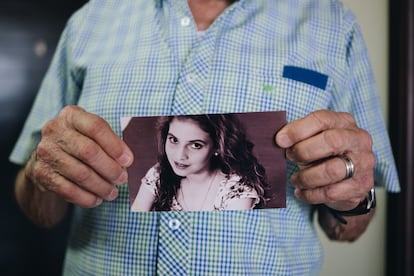 Martin Mestre holds a portrait of Nancy Mariana.